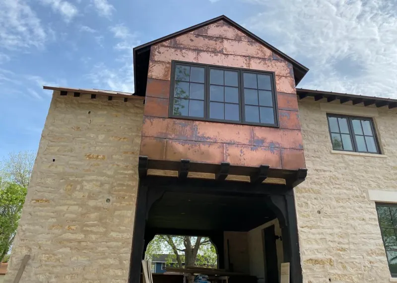 Copper metal panel facade on a stone building for Metal Roof Coating in Denison